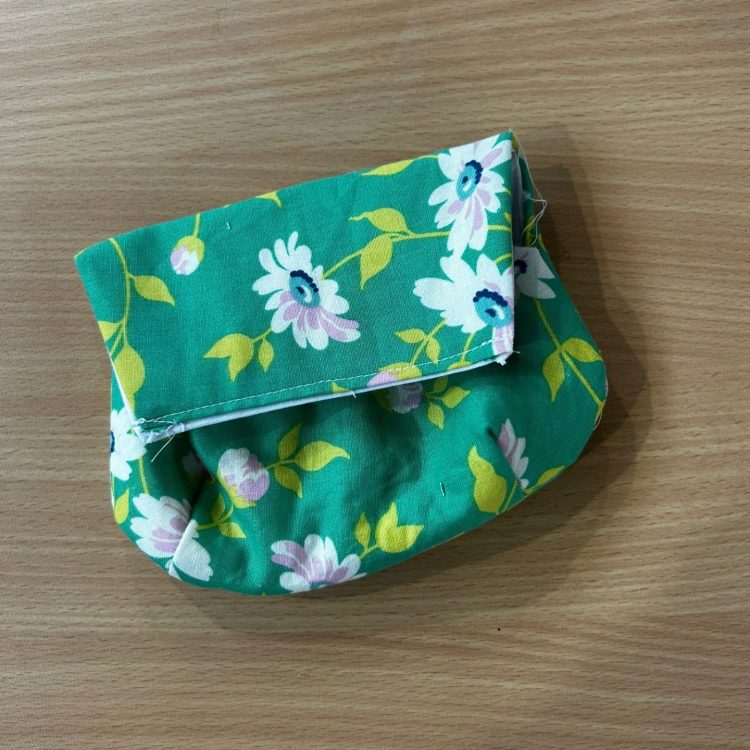 Green flowery purse sewn together by Sunderland Mind Fabric Creations member