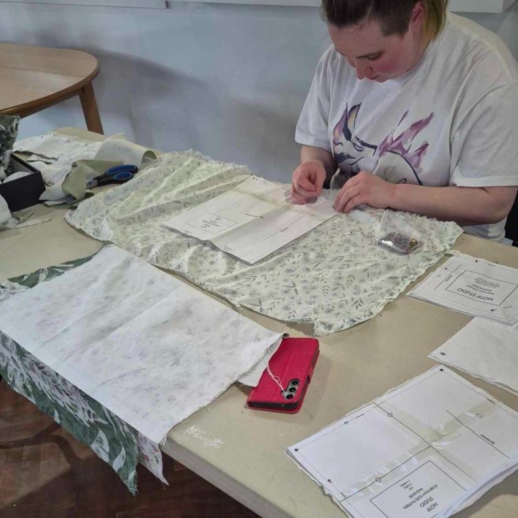 Teenage girl cutting out patterns