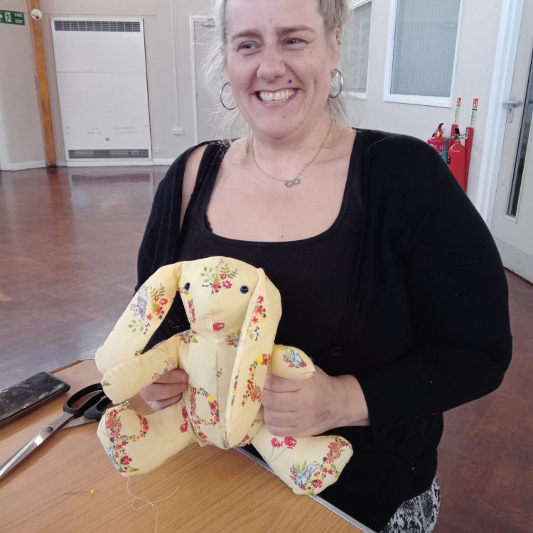 Yellow flowery rabbit sewn by Sunderland Mind Fabric Creations member