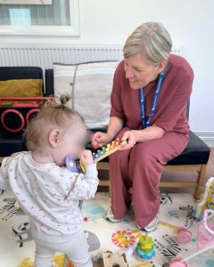 Marsha Jardine our Family Wellbeing Support Worker at Sunderland Mind with making music with a play parade member