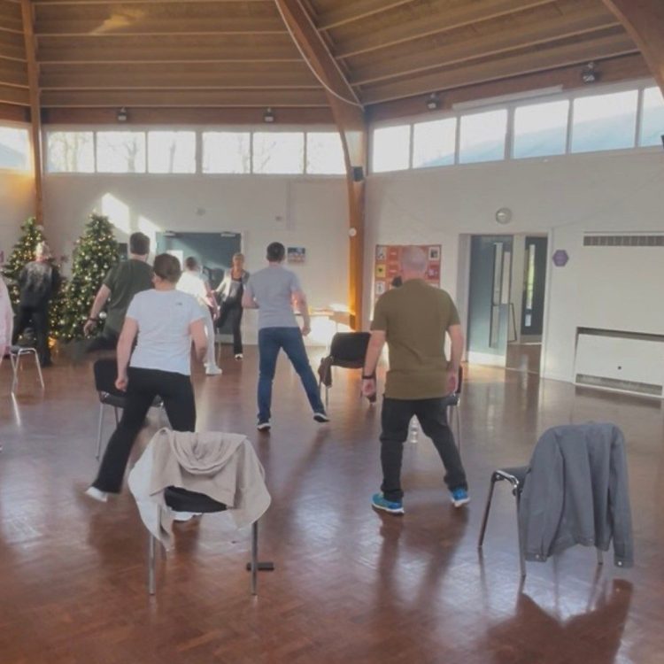 Group taking part in exercise warm up