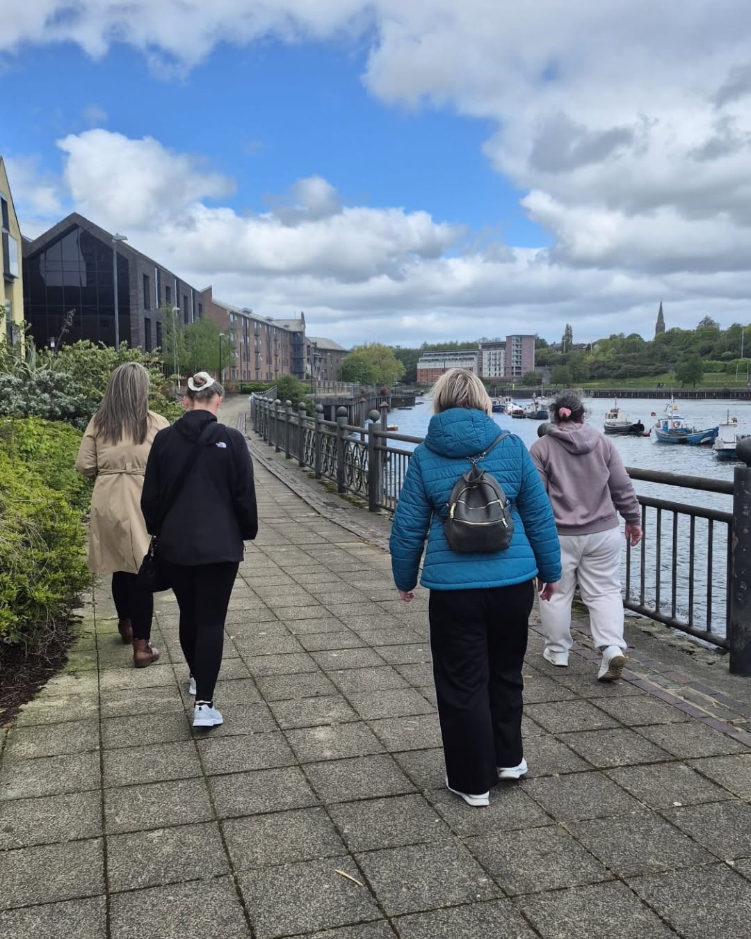 Four women walking along the River Wear